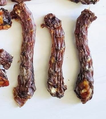 Image of three dehydrated duck necks on a white background