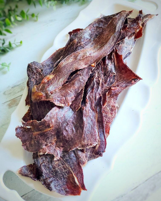 Image of elk treat strips on a white plate 