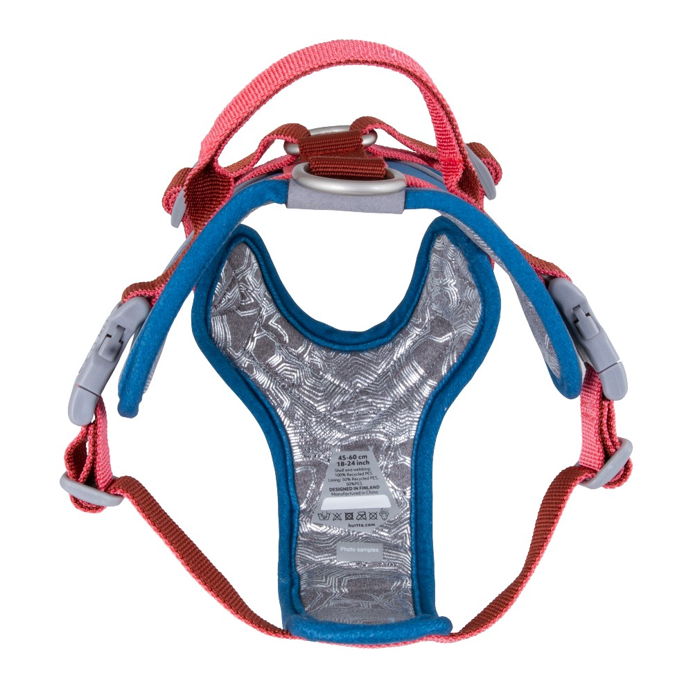 Blue and red dog harness with adjustable straps and clip on a white background 