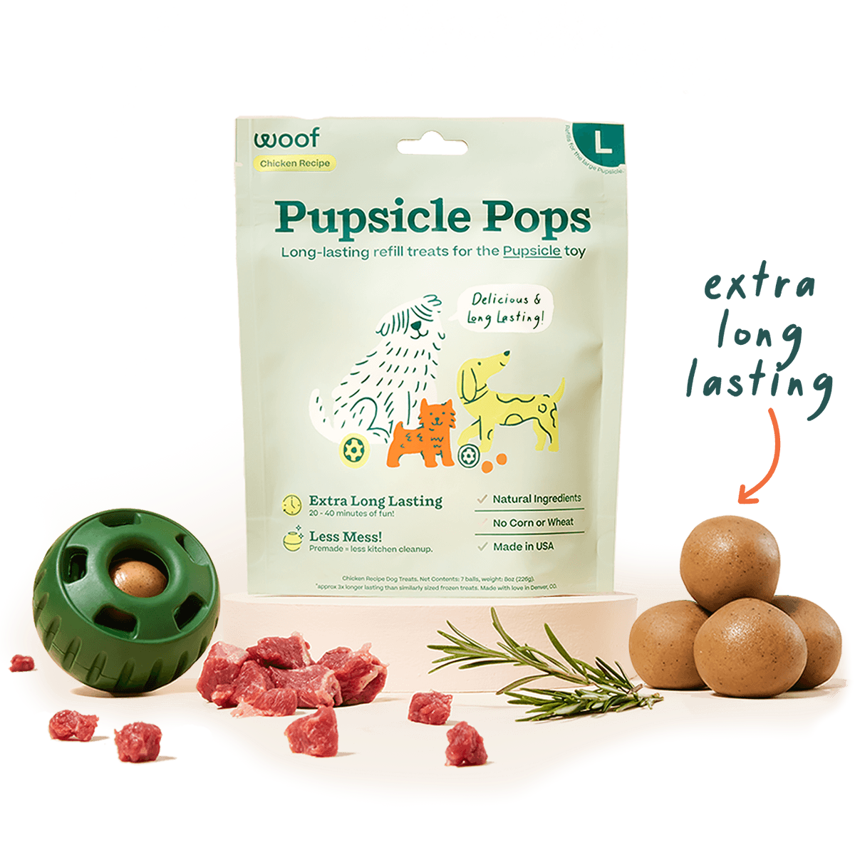 Image of large chicken recipe pupsicle pops with a green pupsicle ball and pieces of meat. 