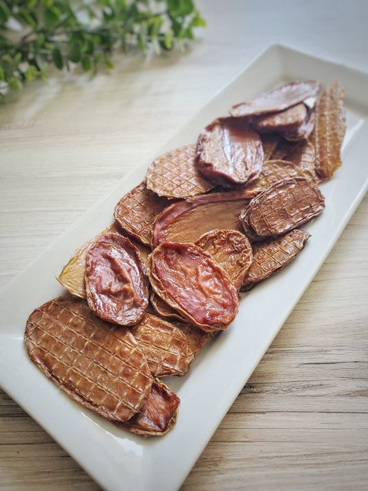 Image of bison fries on a white plate sitting on a light wood surface