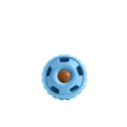 a light blue rubber ball with holes and a brown treat inside