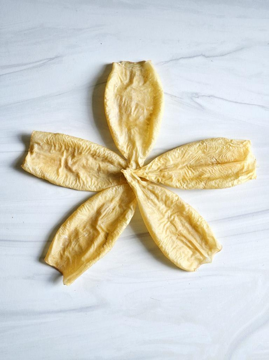 Image of five pieces of squid on a white marble surface