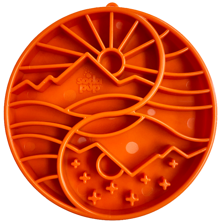 orange slow feeder bowl with a mountain, sun and tree pattern.